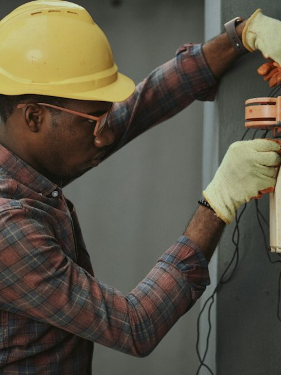 Electrician working at residential electrical service equipment